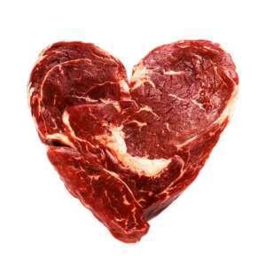 Heart-shaped raw red meat with white marbling on a white background for an article about horse care