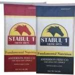 Two 50 lbs bags of STABUL 1 EQUINE DIETS Fundamental Nutrition horse feed from Anderson Feed Co. in red and blue colors with yellow and black label