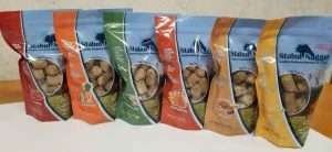 Six bags of Stabul Nuggets horse feed in different flavors arranged on a beige countertop