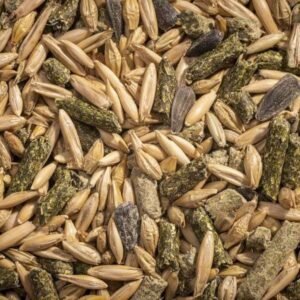 Close up of a pile of mixed light and dark brown grains and black oblong seeds